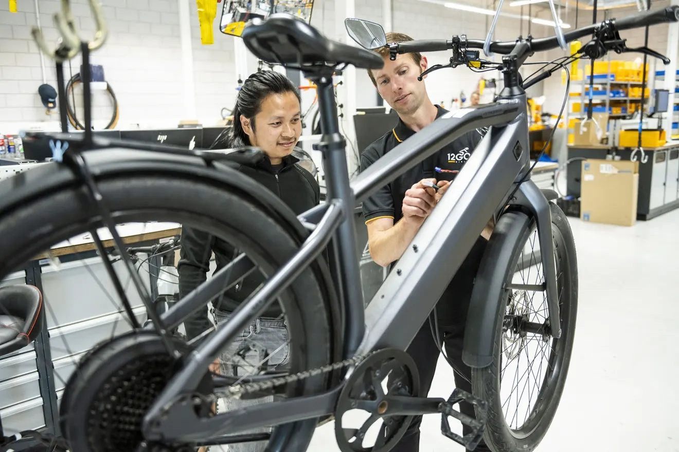 Leerling fietstechnicus aan het werk in de werkplaats